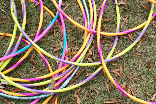 Colorful Hula Hoops Form Circles Lying On Grass — Stock Photo, Image