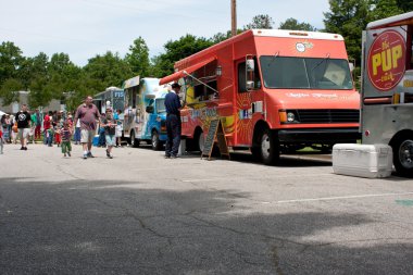 Buy Meals From Food Trucks At Festival clipart