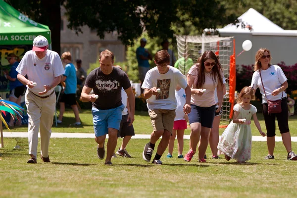 Several Compete In Egg And Spoon Race At Festival — Stock Photo, Image