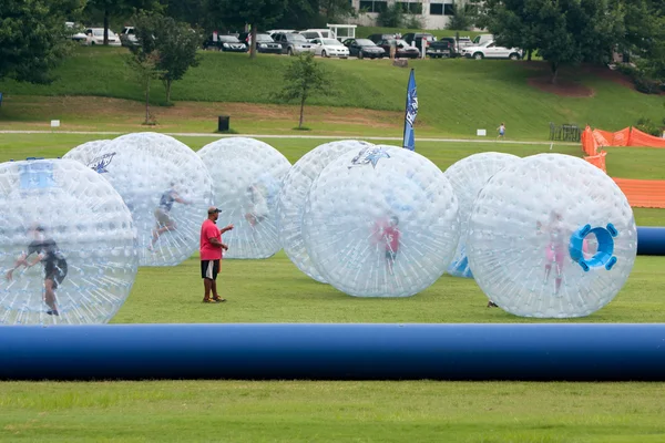 Several Kids Roll Around In Large Zorbs At Summer Festival — Stock Photo, Image