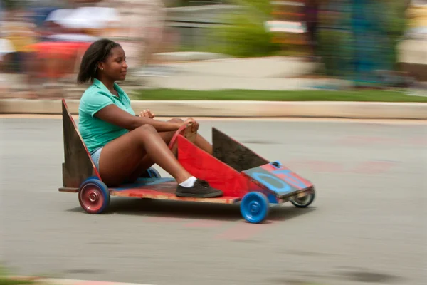 Motion Blur Of Girl Steering Car In Soap Box Derby — Stock Photo, Image