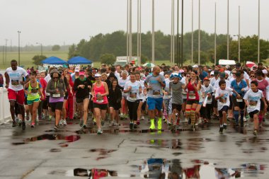 Runners Take Off At Start Of Wet Race In Atlanta clipart