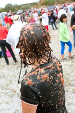 Woman Stands Covered In Tomato Pieces After Huge Food Fight clipart