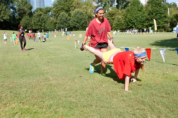 Dos mujeres jóvenes compiten en Wheelbarrow Race en la recaudación de fondos de verano —  Fotos de Stock