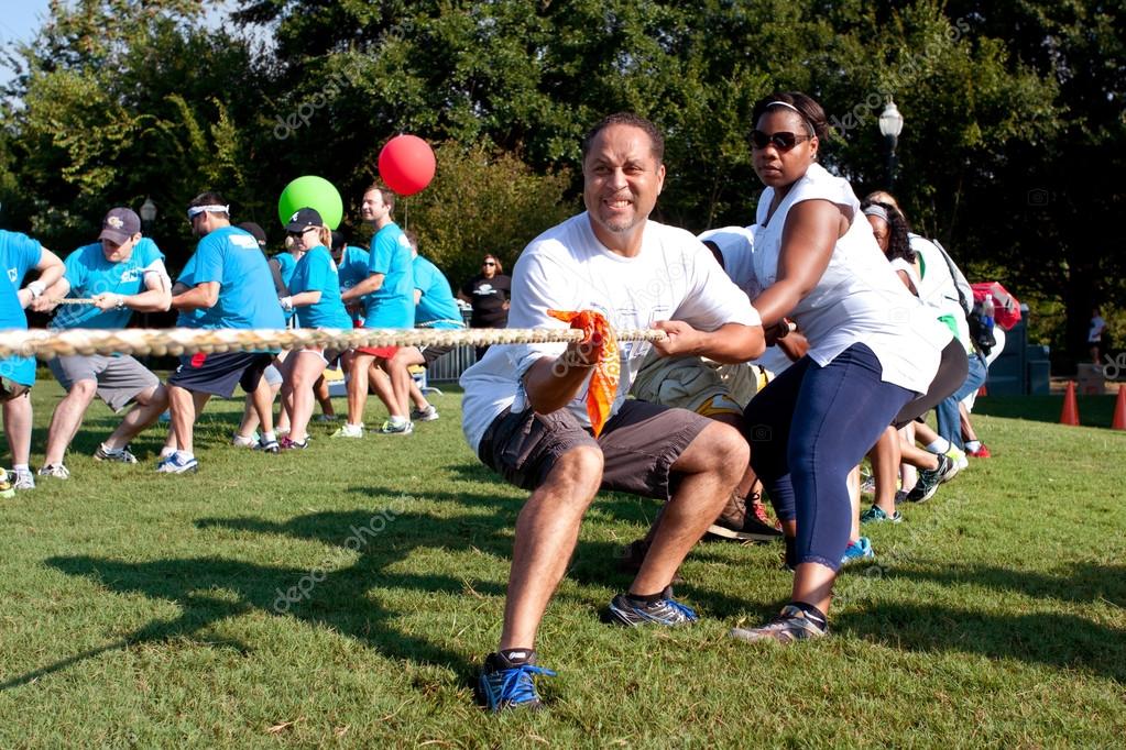 Two Teams Pull Ropes In Adult Tug-Of-War Fundraiser — Stock