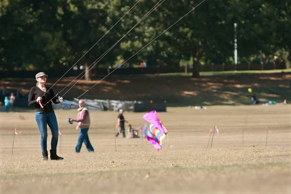 Woman Holds Ropes And Steers Kite At Autumn Festival — Stock Photo, Image