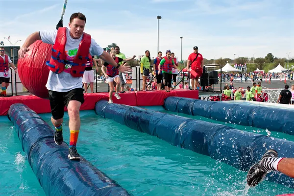 Man Runs Through Wrecking Balls At Crazy Obstacle Race — Stock Photo, Image