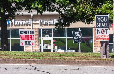 LAWRENCEVILLE, GA -  OCTOBER 9:  A person holds a pro life sign outside a Planned Parenthood clinic on October 9, 2021 in Lawrenceville, GA.
