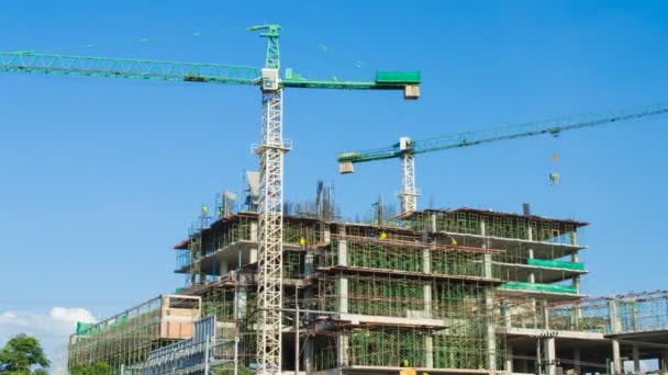 Time lapse crane working in big construction site (zoom in) — Stock Video