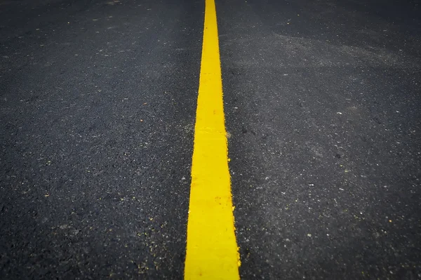 New yellow line on the road texture — Stock Photo, Image