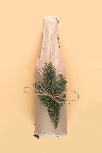 Wine Bottle Wrapped Kraft Paper Christmas Present Beige Background — Stock Photo, Image