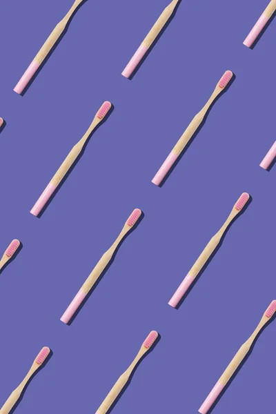 Bamboo toothbrushes on blue background. Seamless repeating pattern.