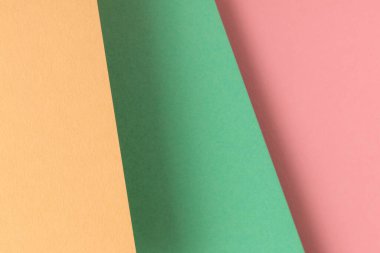 Sarı, turkuaz ve pembe pastel renkli kağıt zemin.