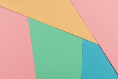 Kağıt arkaplan mavi, turkuaz, sarı ve pembe pastel renklerle.