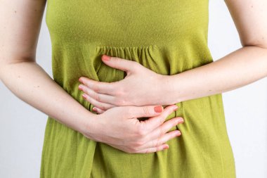 Female hands on stomach. Stomach ache concept.