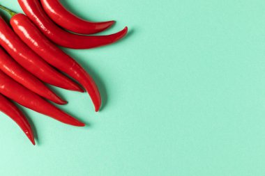 Red hot chili peppers on a blue background. Top view.