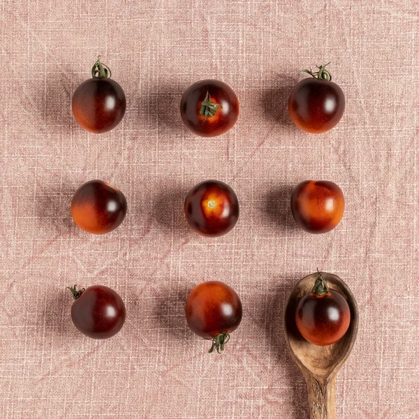 Black strawberry tomatoes on the table. Top view.