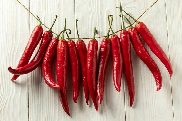 Red Hot Chili Peppers Dried Thread White Wooden Background — Stockfoto