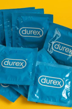 Lviv, Ukraine - August 02, 2022. Durex condoms on yellow background. Top view.