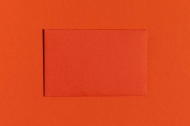 Red greeting card on red background. Minimalistic flat lay.