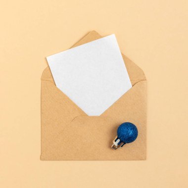 White empty greeting card in an envelope. Christmas background.