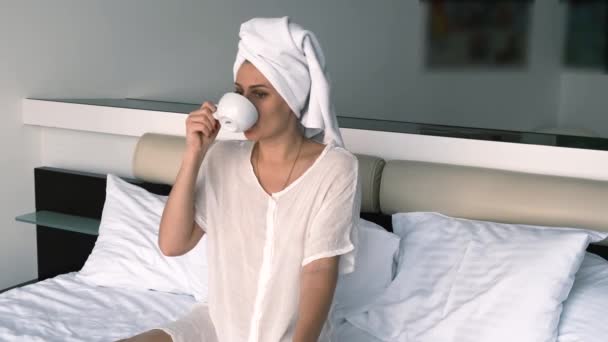 Brooding Girl Bathrobe Towel Drinks Coffee While Sitting Bed — Video