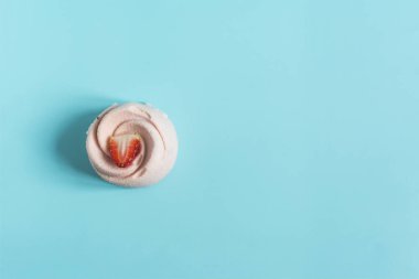 Concept strawberry shortcake with an airy sponge cake on a blue background copy space