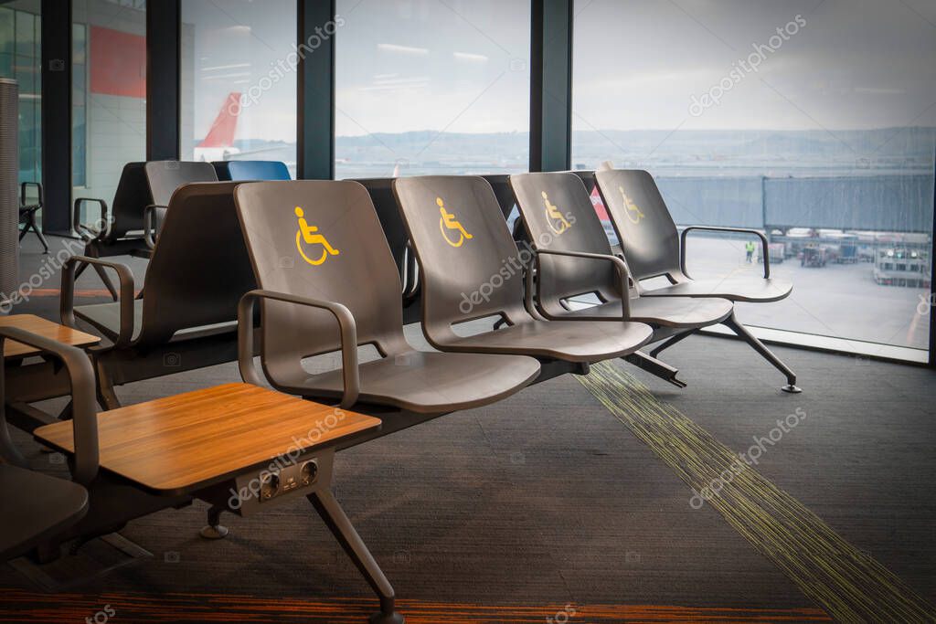 Empty disabled seats at an airport in the waiting area before boarding.