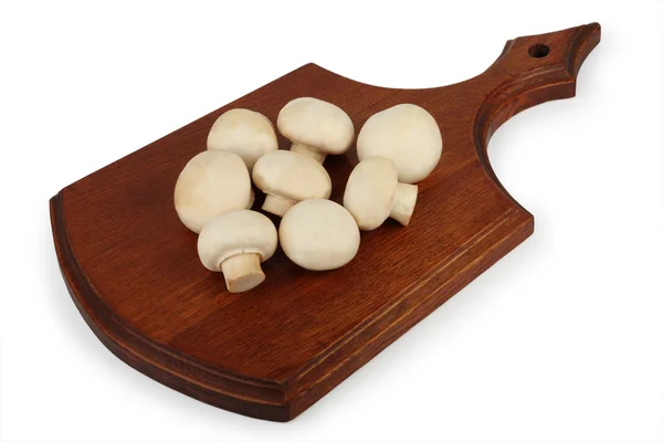 Mushrooms on a wooden chopping board — Stock Photo, Image