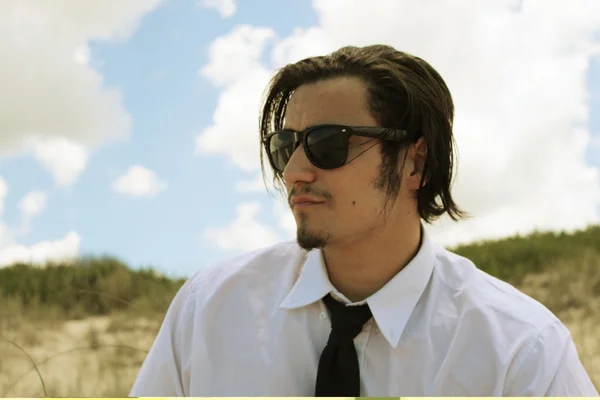 Young male model on beach in suit — Stock Photo, Image