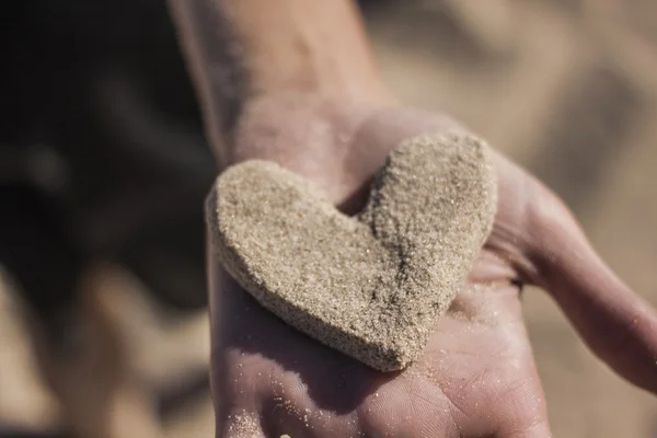 Sand heart in hands — Stock Photo, Image