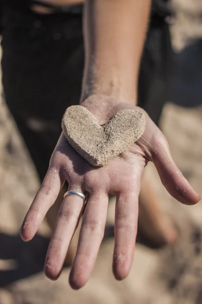 Sand heart in girls hand — Stock Photo, Image