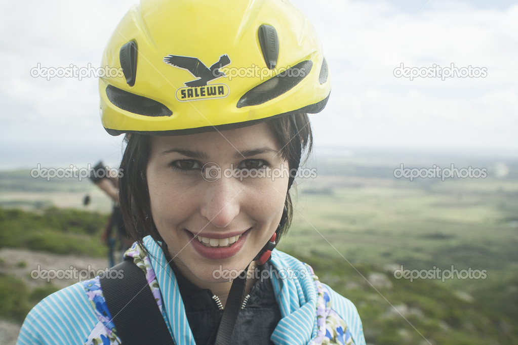 Attractive Young Girl Smiling on Mountain