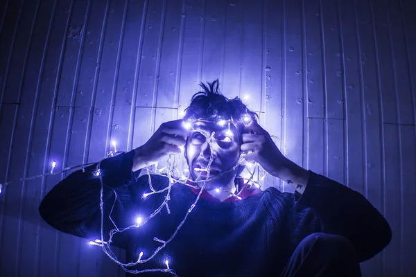 Model trying Hard to Untangle Christmas lights — Stock Photo, Image