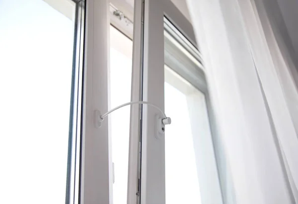 Child lock on the windows of the house, blocking device for opening windows by children. Falling from the window, close-up