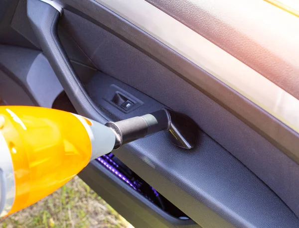 Modern car vacuum cleaner for cleaning the car interior from dust and dirt, close-up. Background — Stock Photo, Image