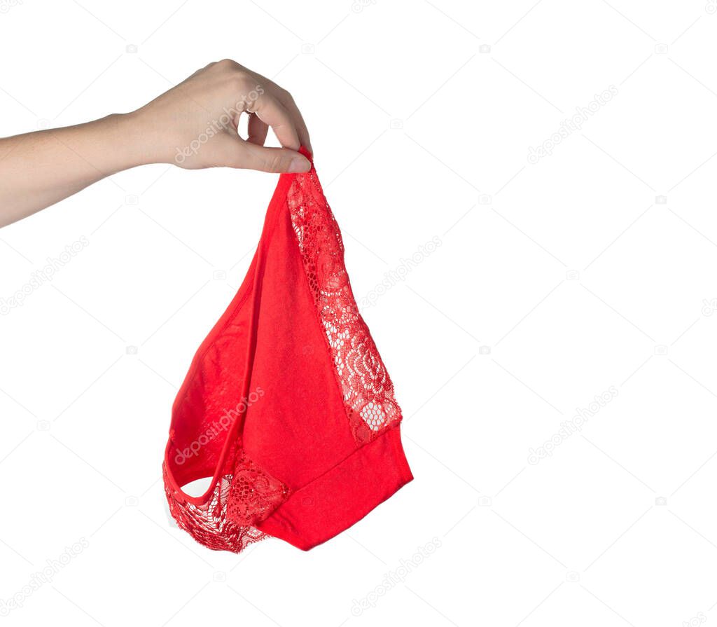 The girl holds red female panties in her hand on a white background. Bad smell from underwear, hygiene