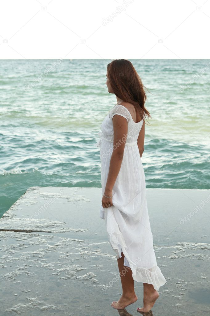 Girl in white dress on the beach