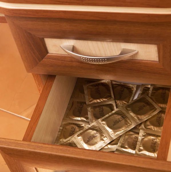 Condoms in desk drawer — Stock Photo, Image