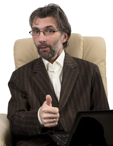 Happy businessman sitting in chair with notebook — Stock Photo, Image