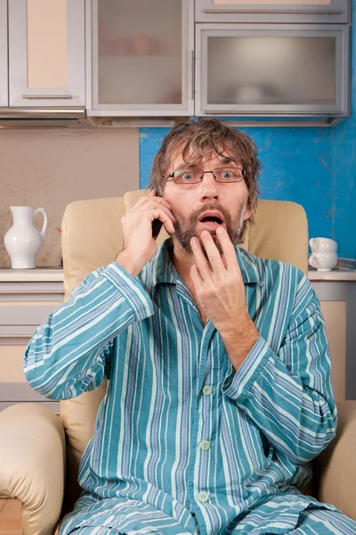 Man sitting in chair with mobile phone — Stock Photo, Image