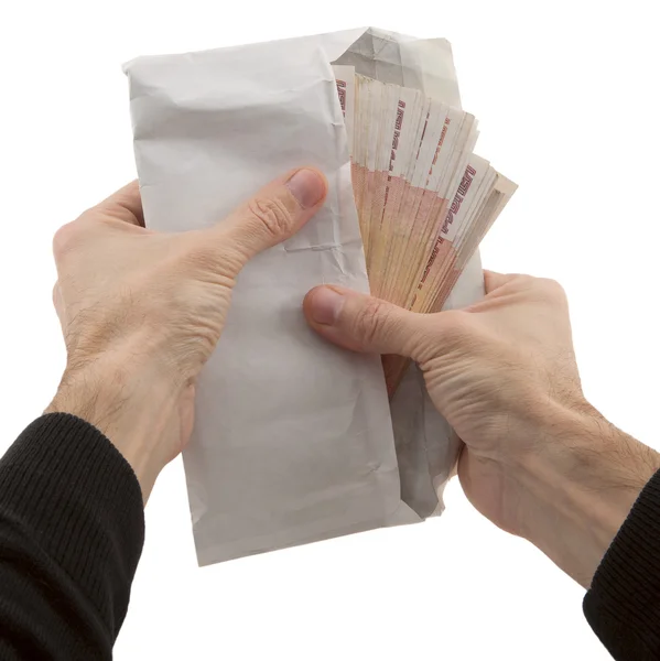 Man 's hands holding envelope with banknote — стоковое фото