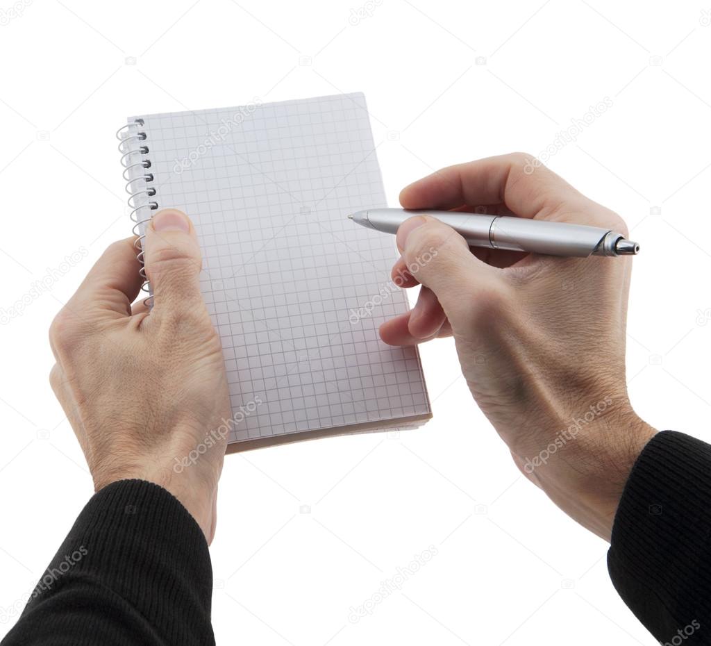 man's hands holding notebook and pen