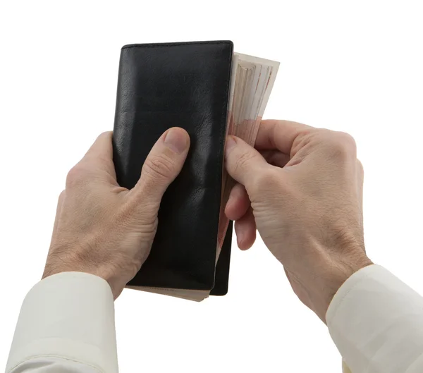 Руки людини приховують гаманець з банкнотою — стокове фото