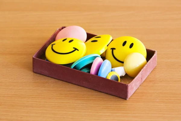 Box with magnetic smiles on tabletop — Stock Photo, Image