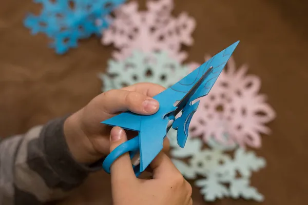 Child Cuts Snowflake Out Paper — Stock Photo, Image