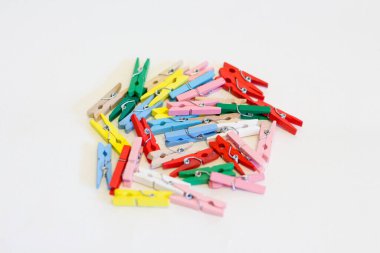 The texture of small multi-colored wooden clothespins.