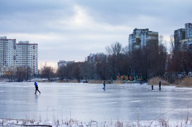 Aptal insanlar Kiev 'deki bir gölde ince buzda kayıyorlar.