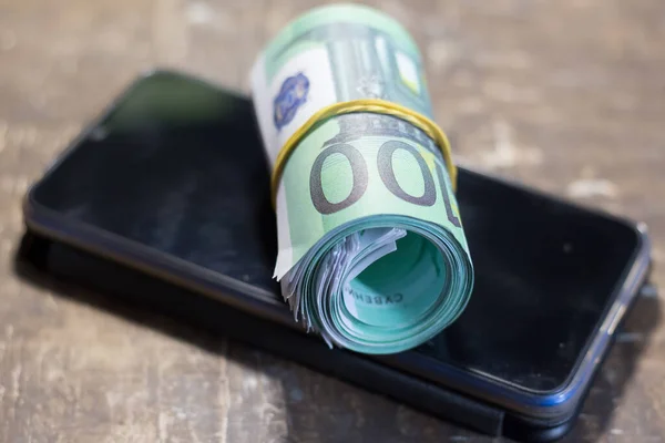 Money banknotes on a mobile phone. Increase in prices due to the war in Ukraine