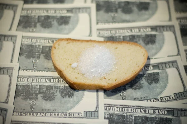 Bread with sugar on banknotes. Increasing the cost of food due to the war in Ukraine
